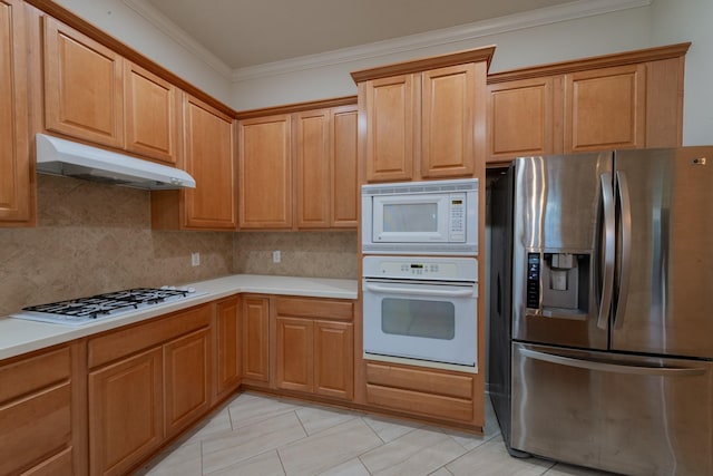 5226 Englewood Point Ct, Katy, TX 77494 - kitchen with white appliances, under cabinet range hood, crown molding, tasteful backsplash, and light countertops