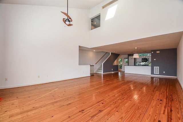 6935 Yellowstone Way Dr, Houston, TX 77054 - unfurnished living room with light wood-style floors, stairway, and baseboards
