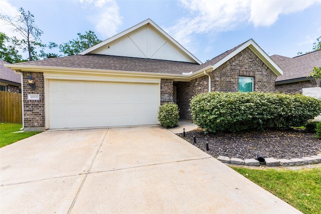 16935 Lagos Ln, Crosby, TX 77532 - view of front of house featuring brick siding, driveway, an attached garage, and roof with shingles