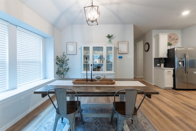 16935 Lagos Ln, Crosby, TX 77532 - dining area with a chandelier, light wood-type flooring, and baseboards