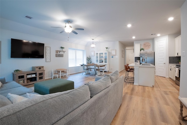 16935 Lagos Ln, Crosby, TX 77532 - living room featuring light wood-style floors, ceiling fan, and recessed lighting
