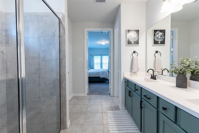 16935 Lagos Ln, Crosby, TX 77532 - ensuite bathroom featuring double vanity, a tile shower, baseboards, and tile patterned floors