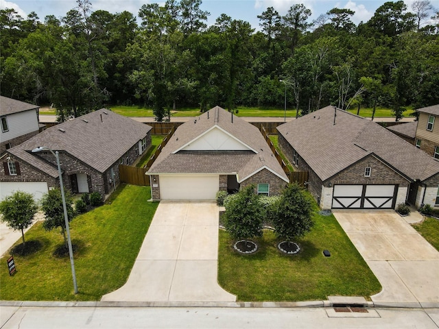 16935 Lagos Ln, Crosby, TX 77532 - view of front of property with driveway, stone siding, and an attached garage
