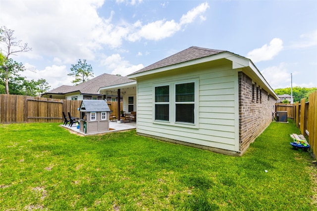 16935 Lagos Ln, Crosby, TX 77532 - back of property featuring a patio area, brick siding, roof with shingles, and central air condition unit