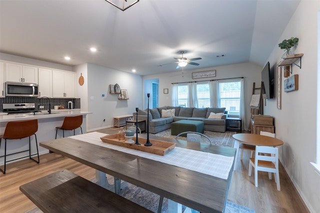 16935 Lagos Ln, Crosby, TX 77532 - living room featuring light wood finished floors, baseboards, a ceiling fan, recessed lighting, and lofted ceiling
