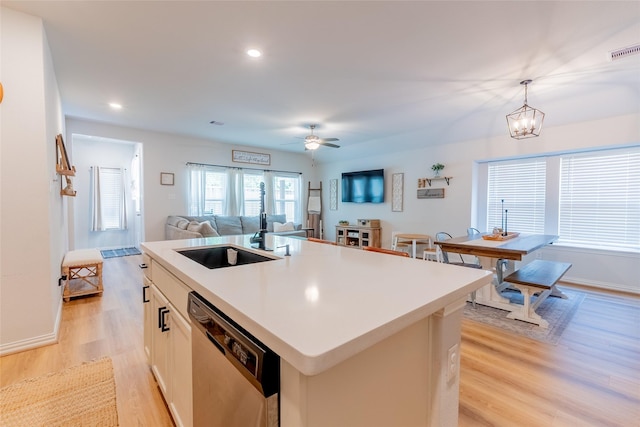 16935 Lagos Ln, Crosby, TX 77532 - kitchen featuring stainless steel dishwasher, a sink, light wood-type flooring, a center island with sink, and ceiling fan