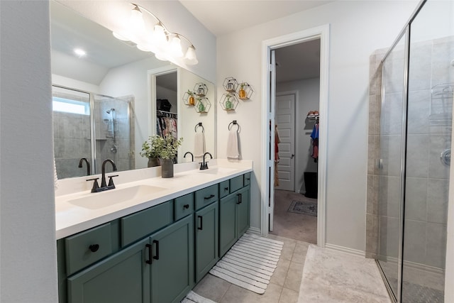 16935 Lagos Ln, Crosby, TX 77532 - bathroom with a spacious closet, double vanity, a shower stall, tile patterned floors, and vaulted ceiling