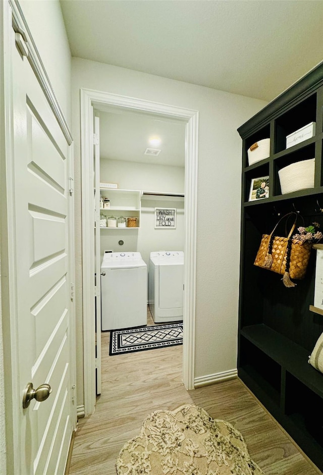 16935 Lagos Ln, Crosby, TX 77532 - mudroom with separate washer and dryer, light wood-style floors, and baseboards