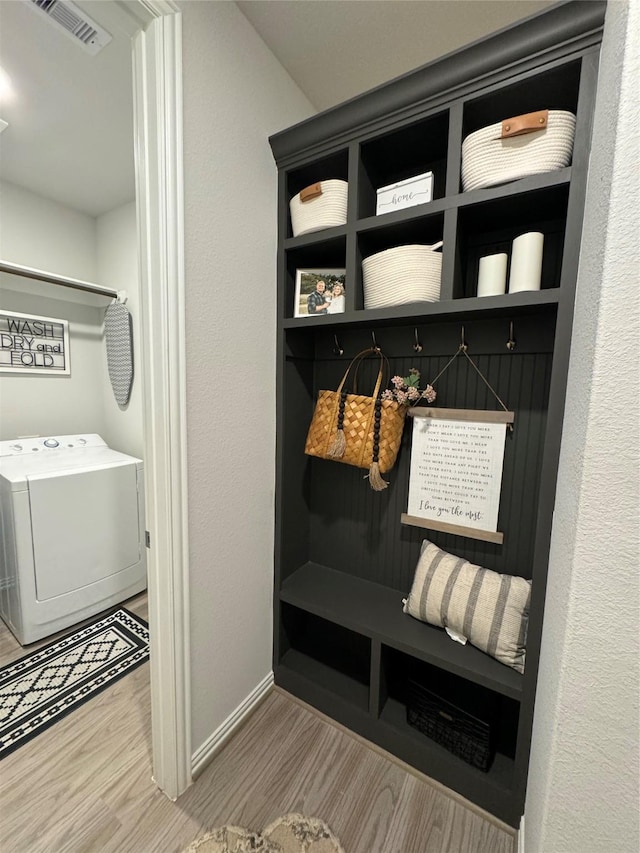 16935 Lagos Ln, Crosby, TX 77532 - mudroom with washer / dryer, wood finished floors, and baseboards