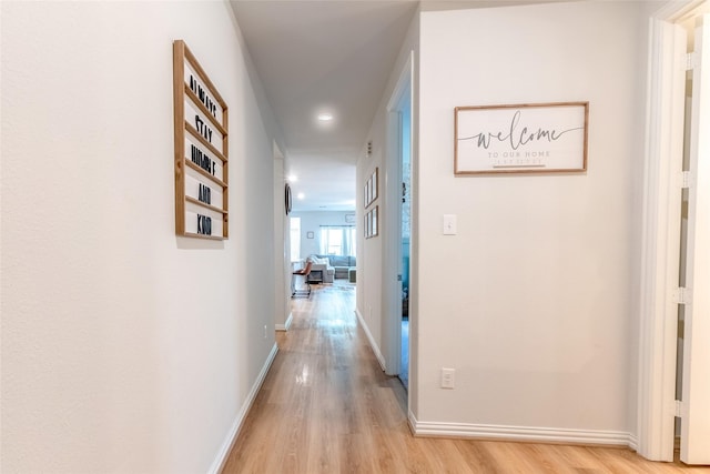 16935 Lagos Ln, Crosby, TX 77532 - corridor with light wood finished floors, baseboards, and recessed lighting