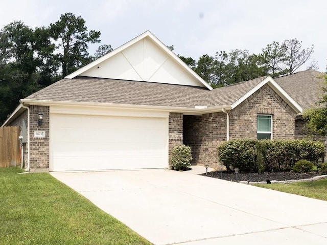 16935 Lagos Ln, Crosby, TX 77532 - view of front of home featuring a garage, driveway, brick siding, and a shingled roof