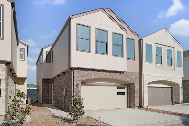 2931 El Fenice Ln, Houston, TX 77057 - view of front facade featuring concrete driveway, an attached garage, stucco siding, and stone siding