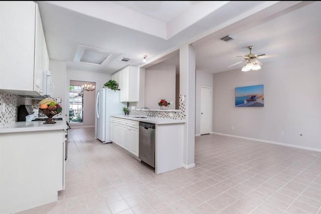 134 Willowwood Cir, The Woodlands, TX 77381 - kitchen with dishwasher, light countertops, freestanding refrigerator, and backsplash