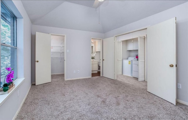 134 Willowwood Cir, The Woodlands, TX 77381 - unfurnished bedroom featuring a closet, vaulted ceiling, washing machine and clothes dryer, light colored carpet, and ensuite bathroom