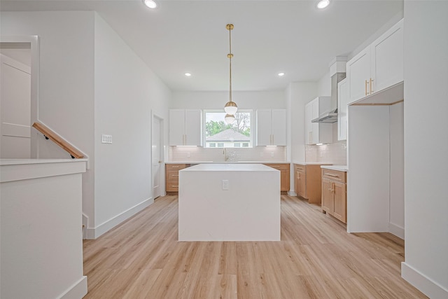 6023 Maybell, Houston, TX 77091 - kitchen with decorative backsplash, a center island, light wood-style floors, recessed lighting, and a sink