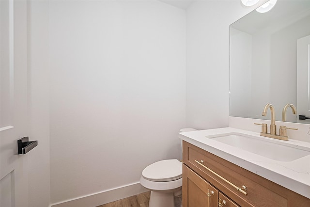 6023 Maybell, Houston, TX 77091 - bathroom featuring vanity, toilet, wood finished floors, and baseboards