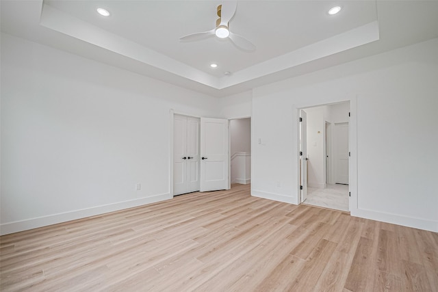 6023 Maybell, Houston, TX 77091 - unfurnished bedroom with a raised ceiling, light wood-type flooring, recessed lighting, baseboards, and ceiling fan