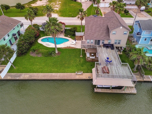 1302 Tiki Dr, Tiki Island, TX 77554 - bird's eye view of a pool area and a large body of water
