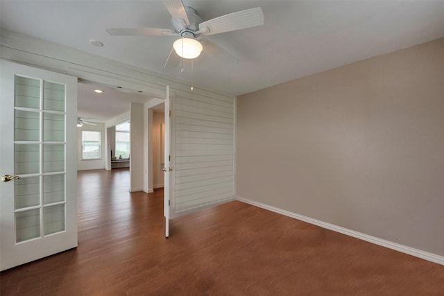 1302 Tiki Dr, Tiki Island, TX 77554 - empty room featuring ceiling fan, wood finished floors, and baseboards