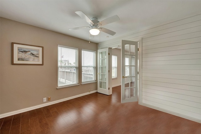 1302 Tiki Dr, Tiki Island, TX 77554 - spare room featuring dark wood-style floors, french doors, baseboards, and a ceiling fan