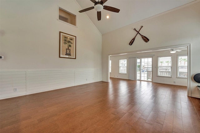 1302 Tiki Dr, Tiki Island, TX 77554 - unfurnished living room with a ceiling fan, high vaulted ceiling, and wood finished floors