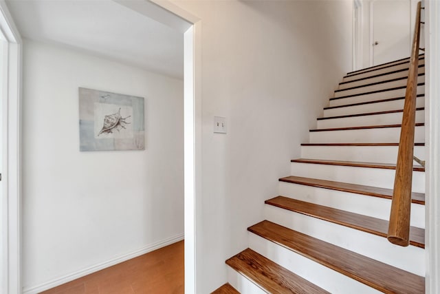 1302 Tiki Dr, Tiki Island, TX 77554 - staircase with wood finished floors and baseboards
