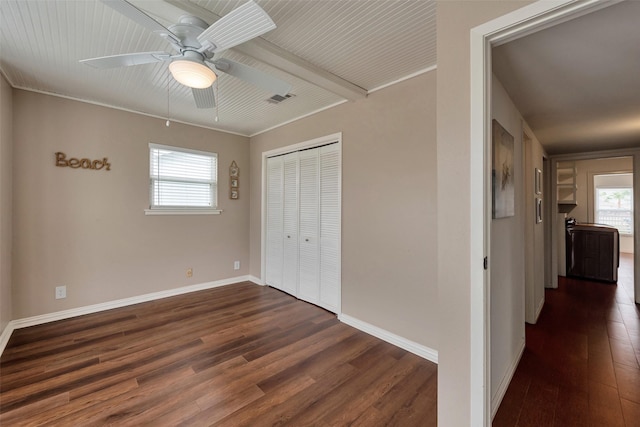 1302 Tiki Dr, Tiki Island, TX 77554 - unfurnished bedroom with dark wood finished floors, a closet, baseboards, and a ceiling fan