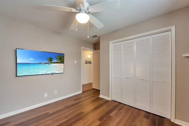 1302 Tiki Dr, Tiki Island, TX 77554 - unfurnished bedroom featuring wood finished floors, a closet, baseboards, and ceiling fan