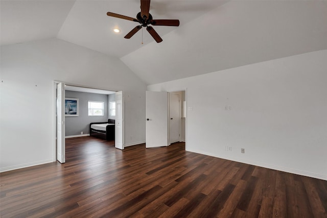 1302 Tiki Dr, Tiki Island, TX 77554 - unfurnished living room with vaulted ceiling, ceiling fan, dark wood finished floors, and baseboards