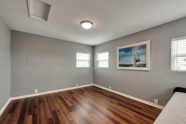 1302 Tiki Dr, Tiki Island, TX 77554 - spare room featuring dark wood-style flooring, plenty of natural light, and baseboards