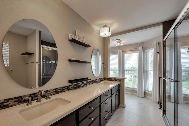 1302 Tiki Dr, Tiki Island, TX 77554 - bathroom featuring double vanity, healthy amount of natural light, a shower with door, and baseboards