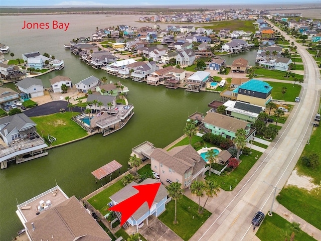1302 Tiki Dr, Tiki Island, TX 77554 - aerial perspective of suburban area featuring a large body of water