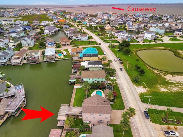 1302 Tiki Dr, Tiki Island, TX 77554 - aerial perspective of suburban area with a nearby body of water