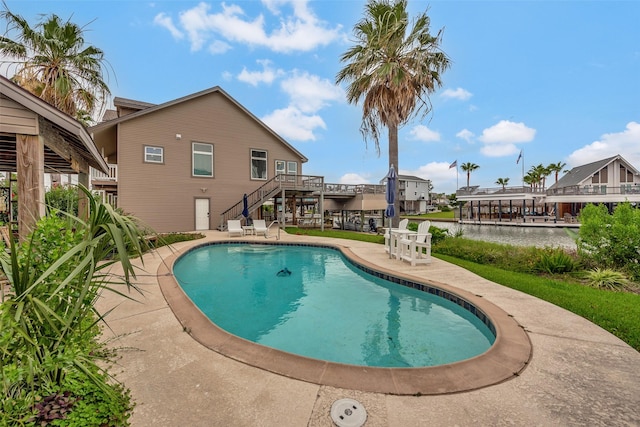 1302 Tiki Dr, Tiki Island, TX 77554 - swimming pool with stairway and a patio