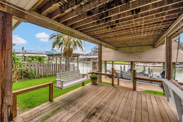 1302 Tiki Dr, Tiki Island, TX 77554 - wooden terrace featuring boat lift, a water view, and a boat dock