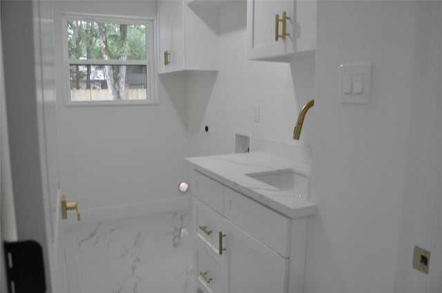 2522 Cassius Ct, New Caney, TX 77357 - laundry room featuring electric dryer hookup, cabinet space, marble finish floors, and washer hookup