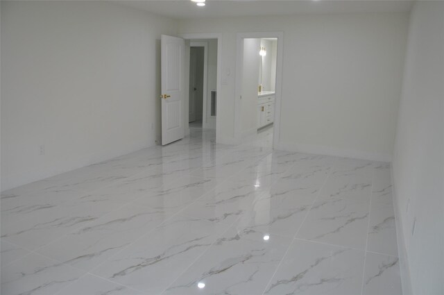 2522 Cassius Ct, New Caney, TX 77357 - empty room featuring light marble finish flooring and baseboards