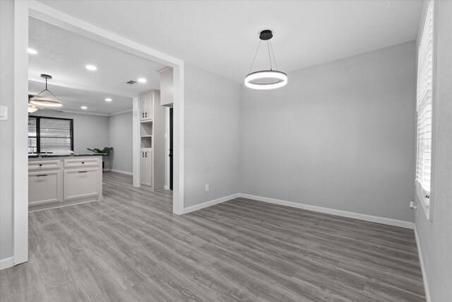 2408 Raymond St, Pasadena, TX 77506 - unfurnished dining area with baseboards, wood finished floors, and recessed lighting