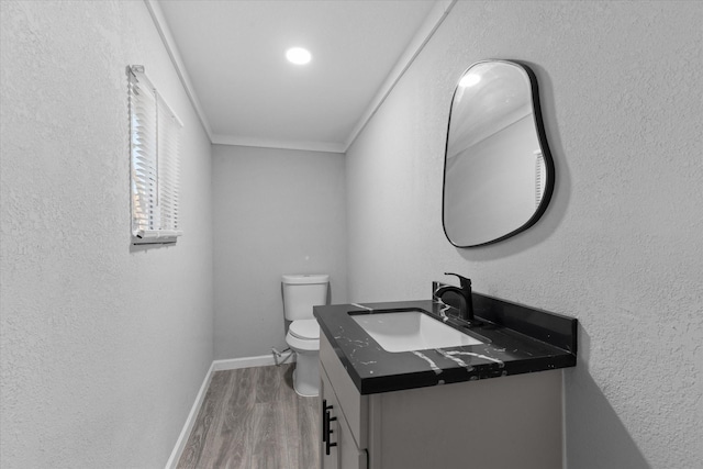2408 Raymond St, Pasadena, TX 77506 - half bath featuring vanity, toilet, wood finished floors, ornamental molding, and baseboards