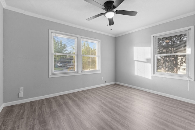 2408 Raymond St, Pasadena, TX 77506 - spare room with crown molding, wood finished floors, a ceiling fan, and baseboards