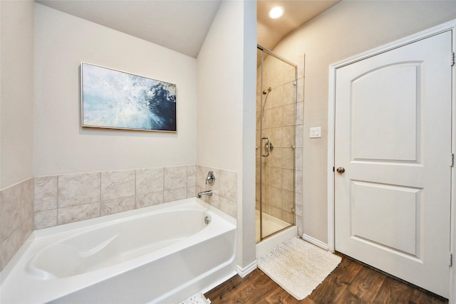 14133 Sharktooth Hill Ln, Conroe, TX 77384 - full bath featuring a bath, wood finished floors, a stall shower, and recessed lighting