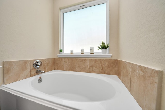 15543 Sheldon Ridge Way, Houston, TX 77044 - full bathroom featuring a textured wall and a bath