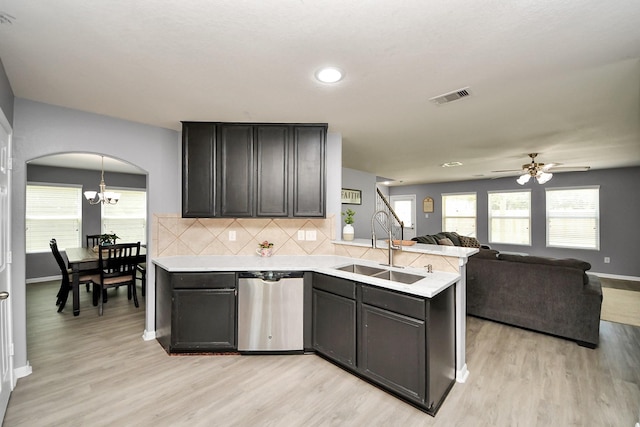 15543 Sheldon Ridge Way, Houston, TX 77044 - kitchen featuring arched walkways, a sink, light countertops, a peninsula, and recessed lighting