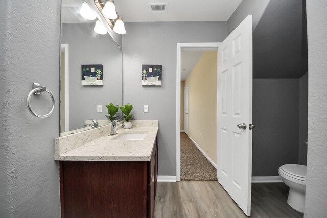 15543 Sheldon Ridge Way, Houston, TX 77044 - bathroom featuring wood finished floors, vanity, toilet, and baseboards