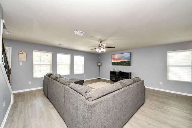 15543 Sheldon Ridge Way, Houston, TX 77044 - living room featuring light wood-type flooring, baseboards, and ceiling fan