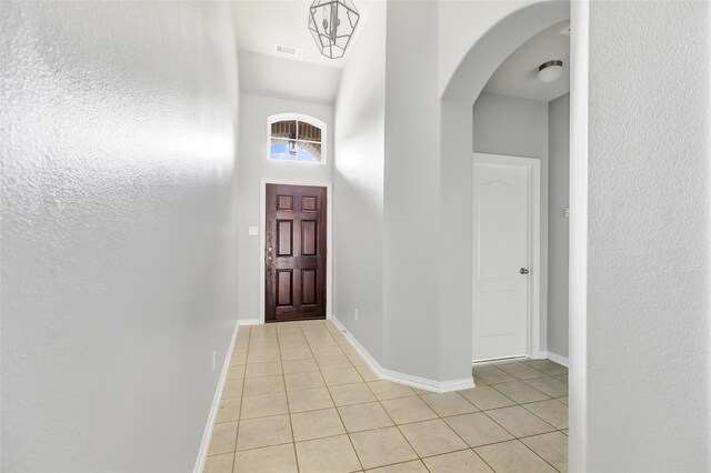 30510 Legend Oaks Ct, Magnolia, TX 77355 - entryway featuring light tile patterned floors, arched walkways, baseboards, and a high ceiling