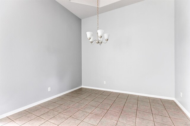 30510 Legend Oaks Ct, Magnolia, TX 77355 - spare room featuring a chandelier, light tile patterned flooring, lofted ceiling, and baseboards