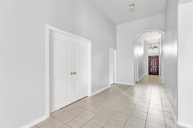 30510 Legend Oaks Ct, Magnolia, TX 77355 - spare room with arched walkways, light tile patterned flooring, and baseboards