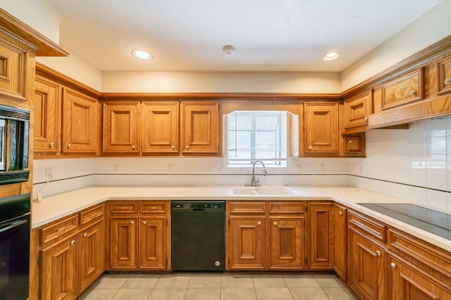 6914 Coral Ridge Rd, Houston, TX 77069 - kitchen featuring black appliances, a sink, brown cabinets, light countertops, and recessed lighting