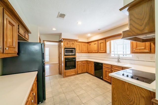 6914 Coral Ridge Rd, Houston, TX 77069 - kitchen featuring black appliances, a sink, light countertops, exhaust hood, and recessed lighting